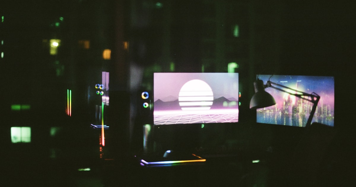 black flat screen tv turned on in a dark room