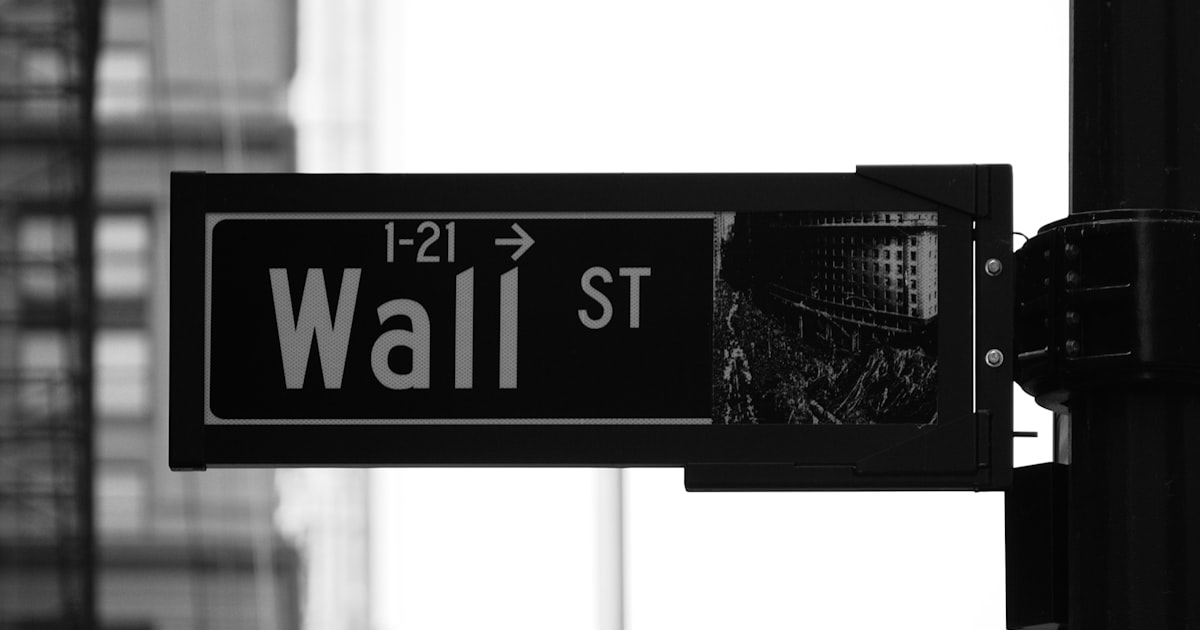 grayscale photo of Wall St. signage