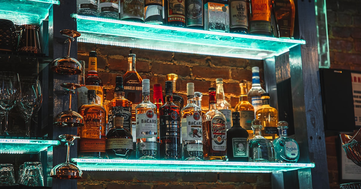 a shelf with bottles of alcohol on it