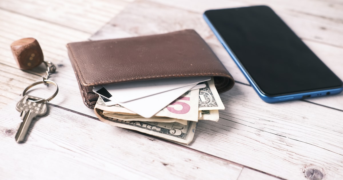 black leather bifold wallet on white table