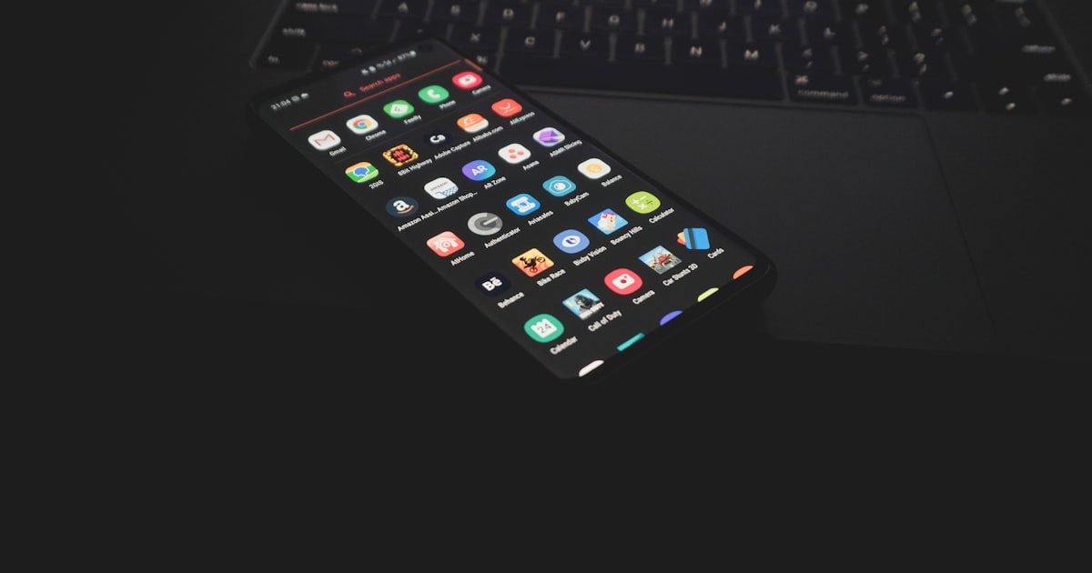 black iphone 5 on black computer keyboard