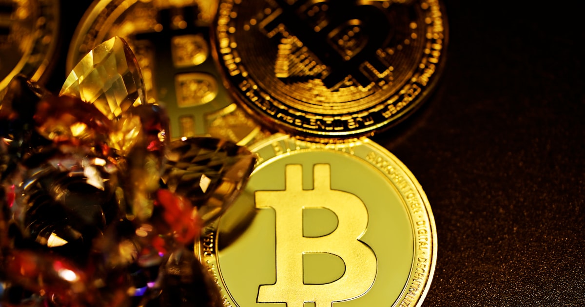 a pile of gold bitcoins sitting on top of a table