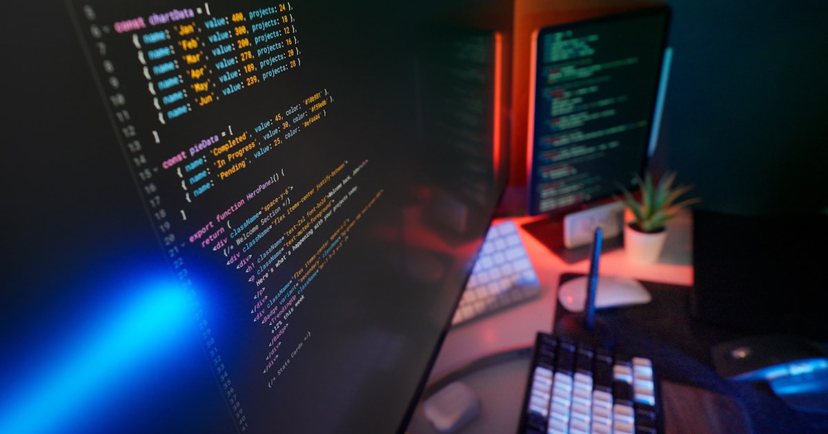 Coding code on multiple computer screens.