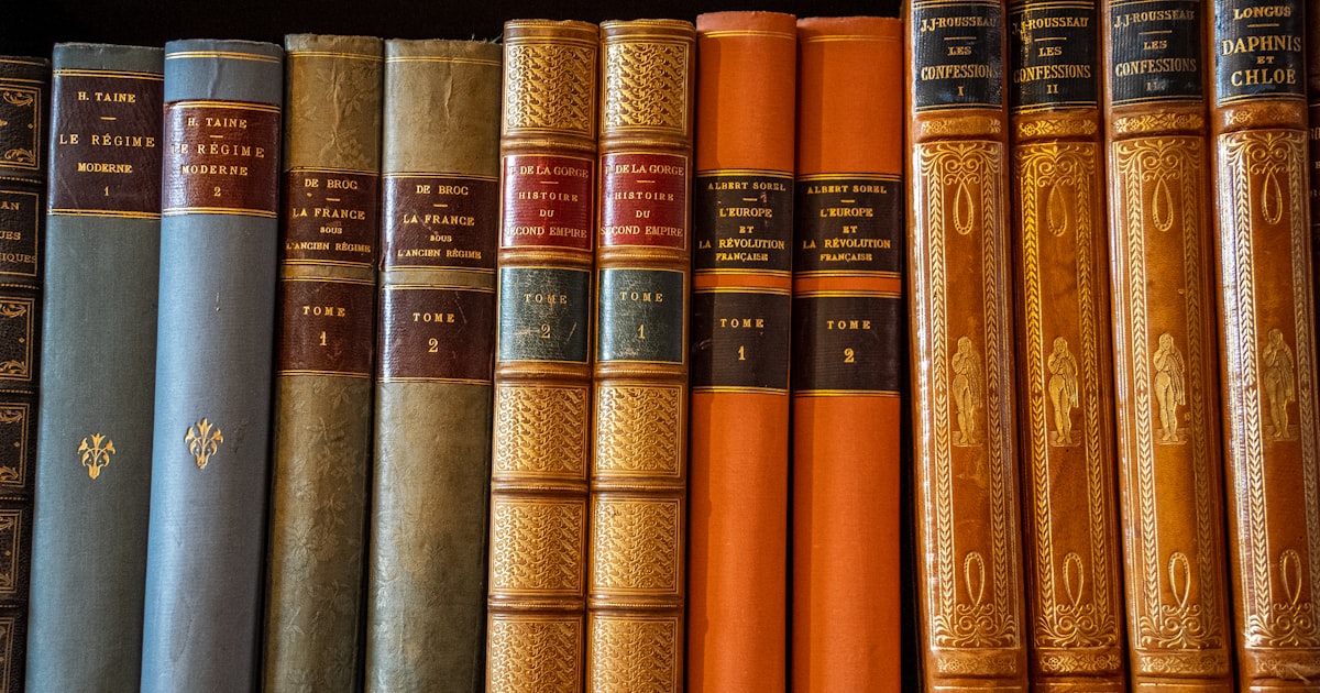 a row of books sitting on top of a shelf