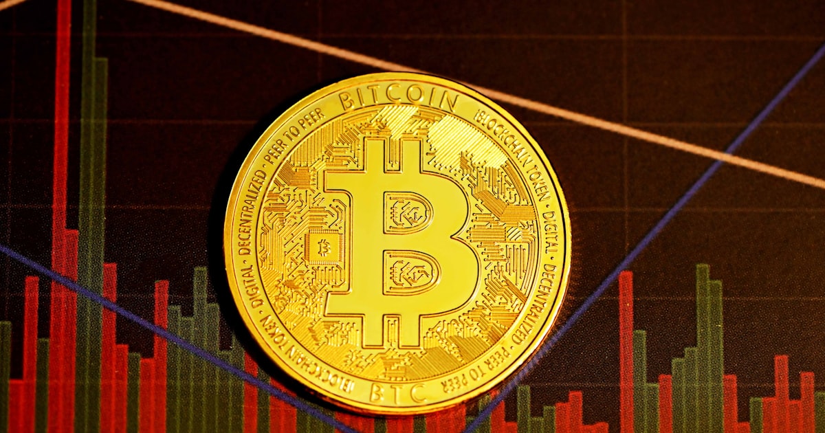 gold round coin on red and black textile