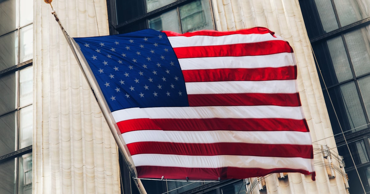 a flag flying in front of a building