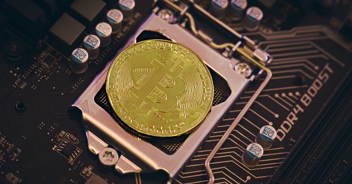 a bit coin sitting on top of a motherboard