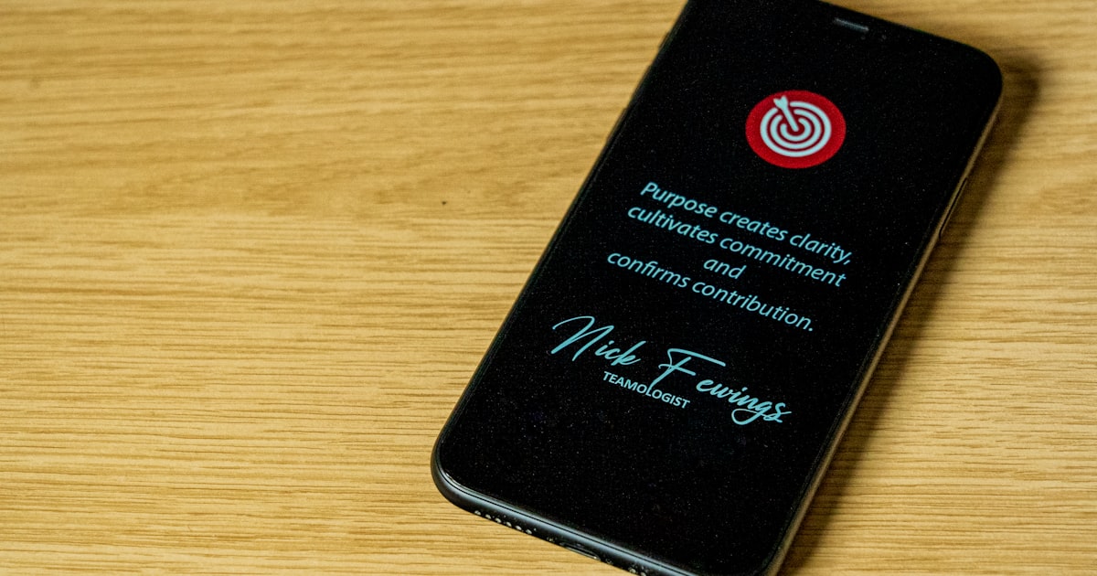 black iphone 7 plus on brown wooden table