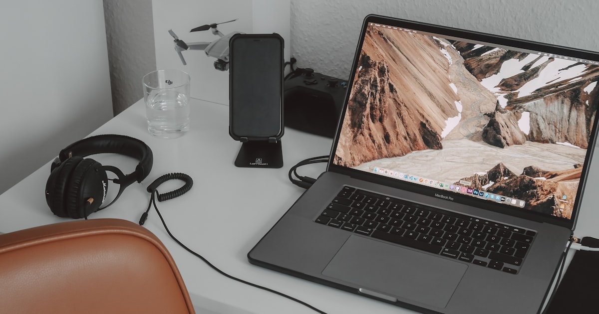 a laptop computer sitting on top of a white desk