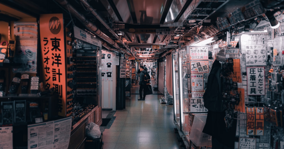 a man is walking down a long hallway