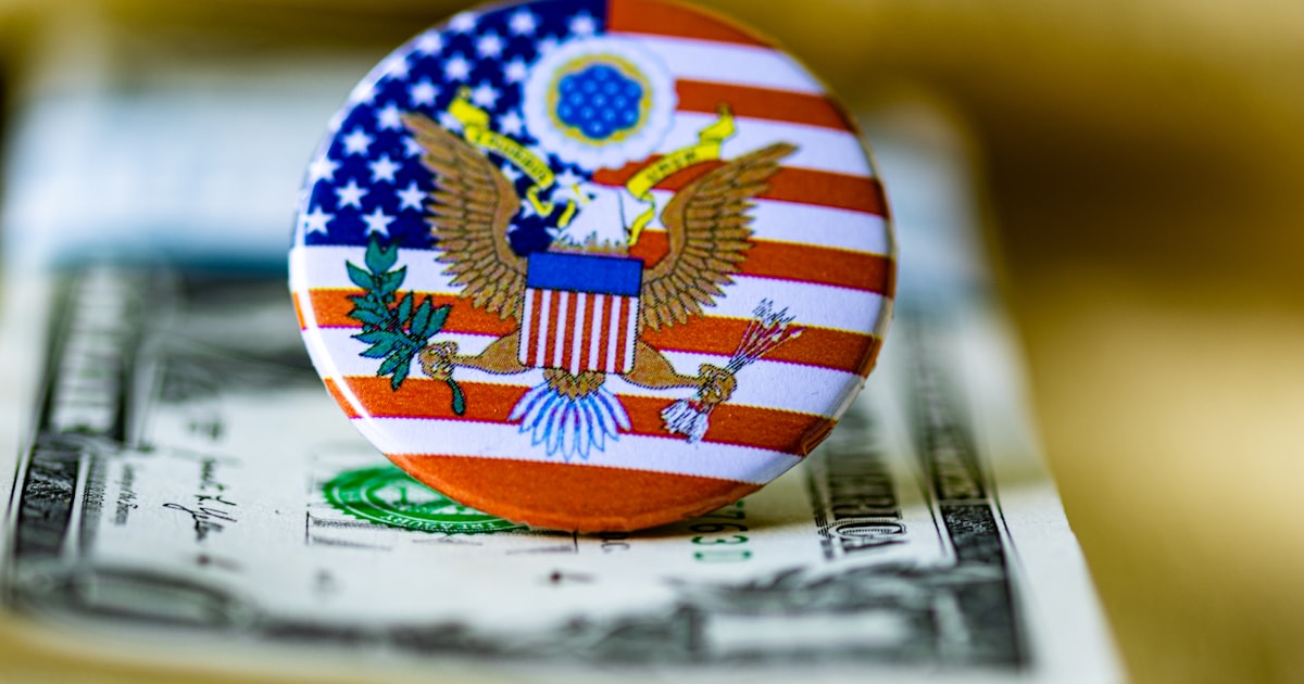 A close up of a button on a dollar bill