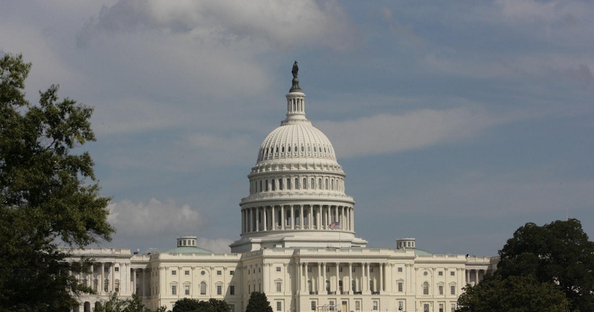 a large white building with trees in front of it