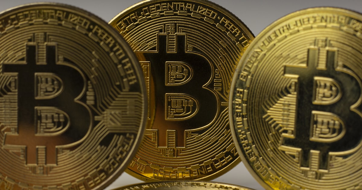 a pile of gold bitcoins sitting on top of each other