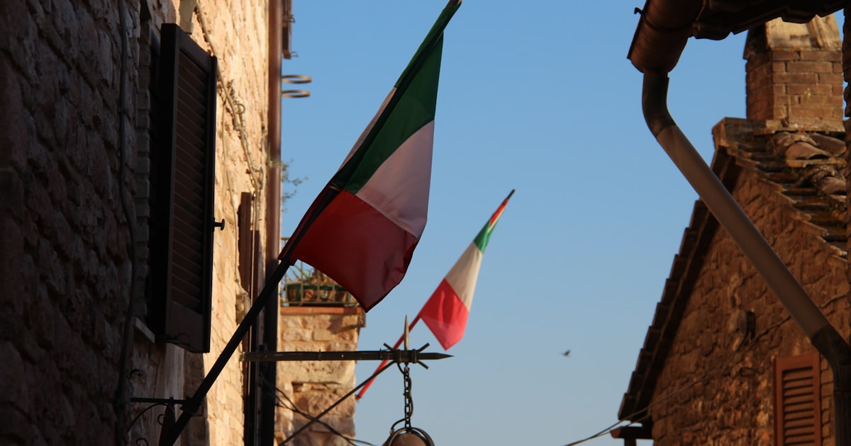 a flag flying in the wind next to a building