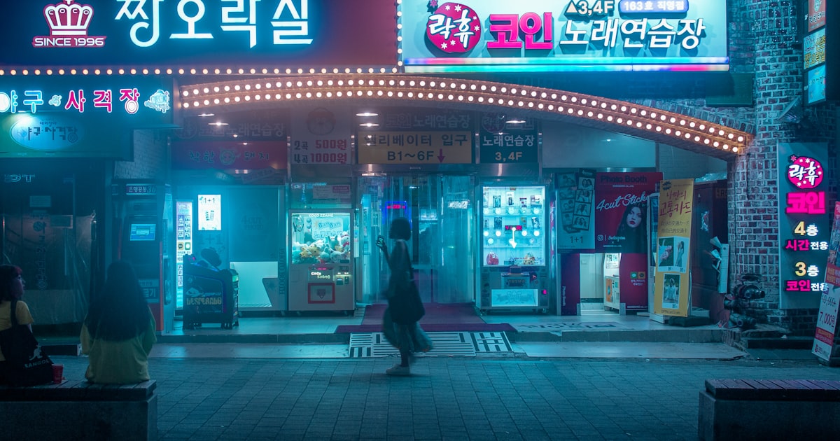 person carrying bag walking in front of store