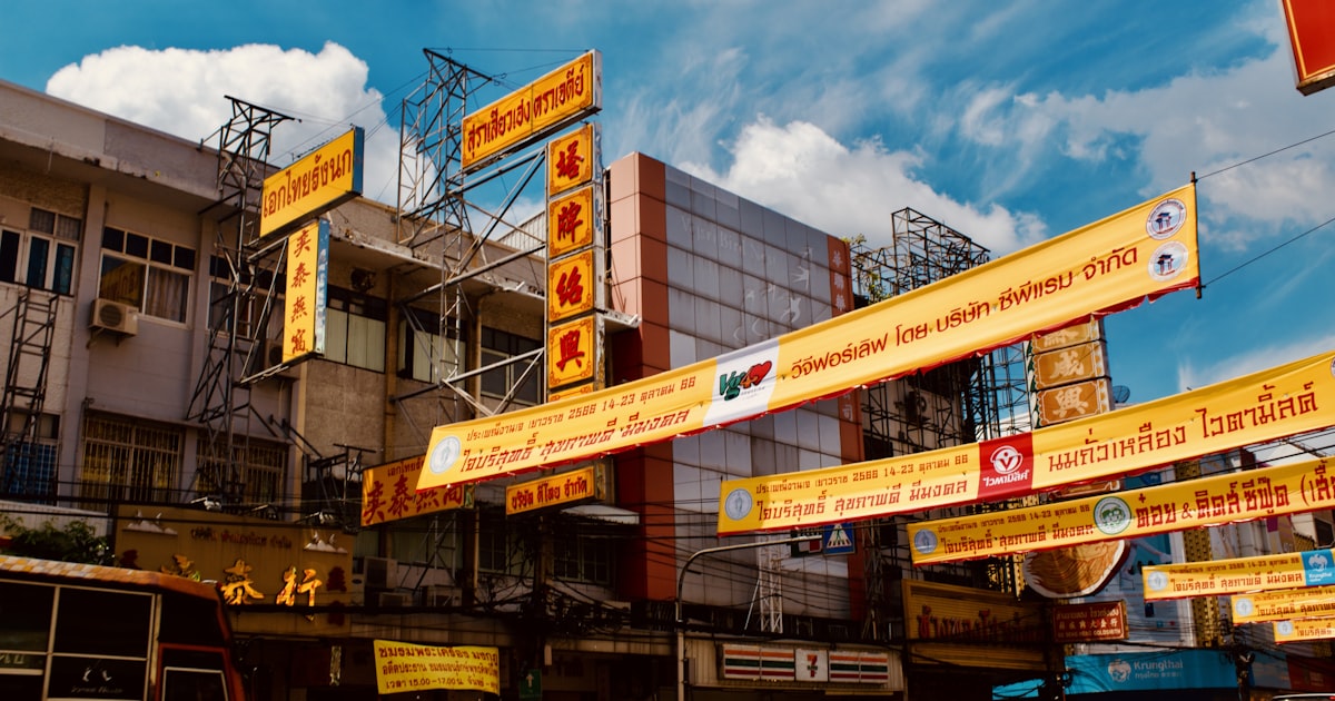 a bunch of signs hanging from the side of a building