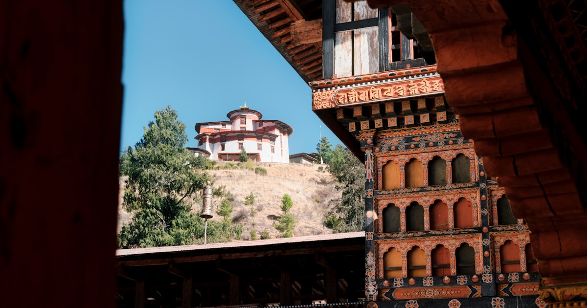 Traditional bhutanese architecture with a building on a hill.