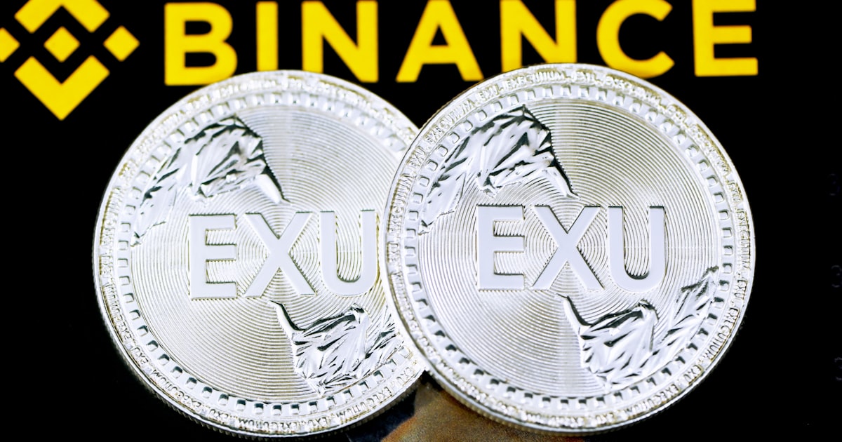 silver round coin on black and yellow textile