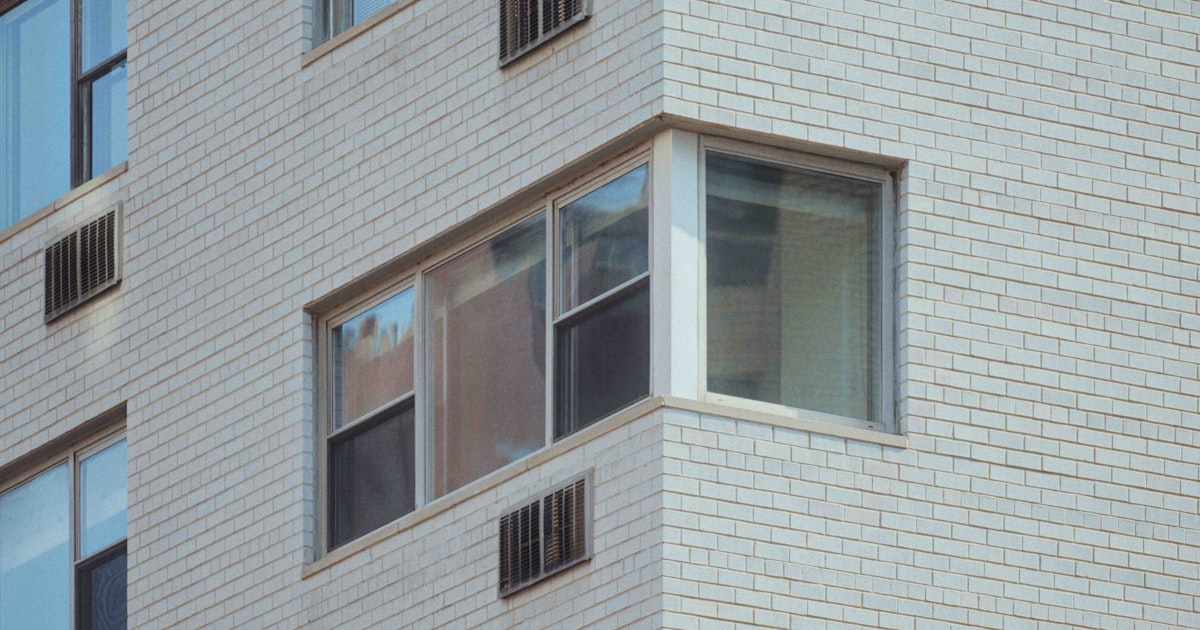 a clock on the side of a tall building