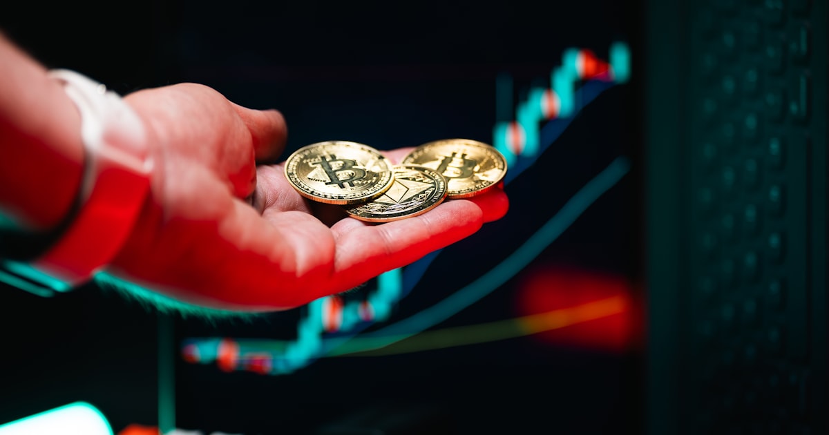 A person holding two gold coins in their hand