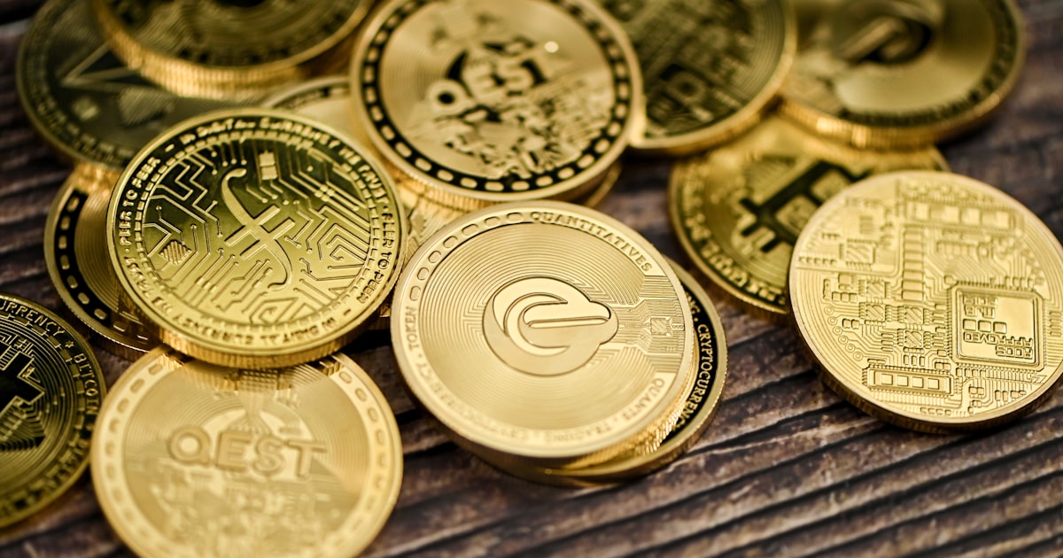 a pile of gold coins sitting on top of a wooden table