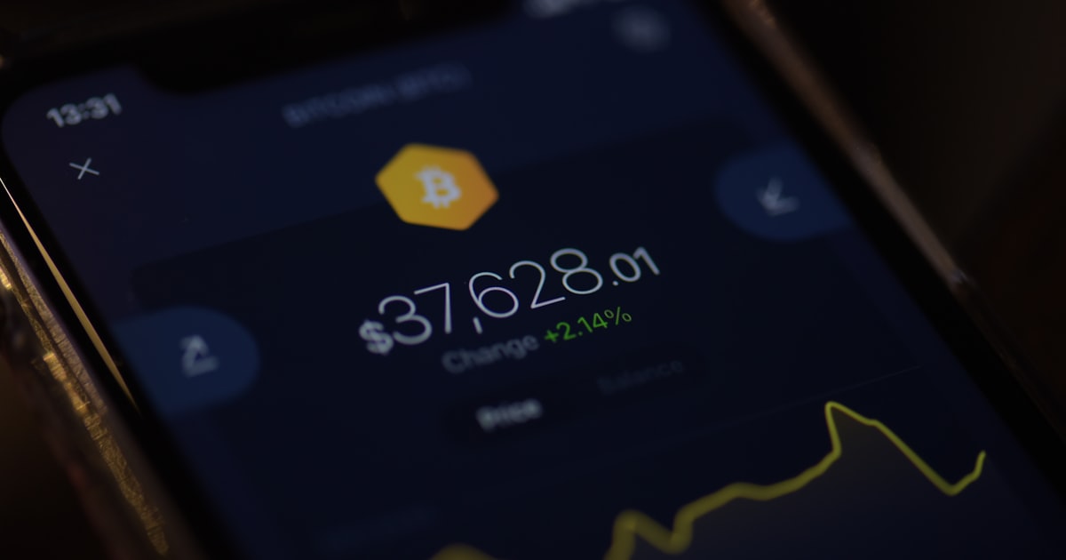 a close up of a cell phone with a bitcoin on it