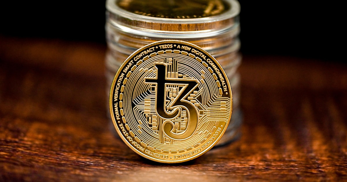 a stack of coins sitting on top of a wooden table