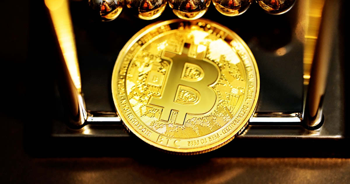 gold round coin on black surface