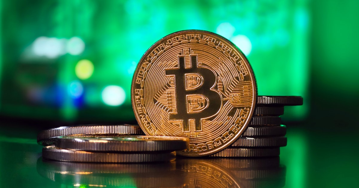 a bit coin sitting on top of a stack of coins