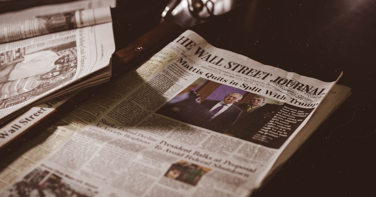 newspaper on black wooden table