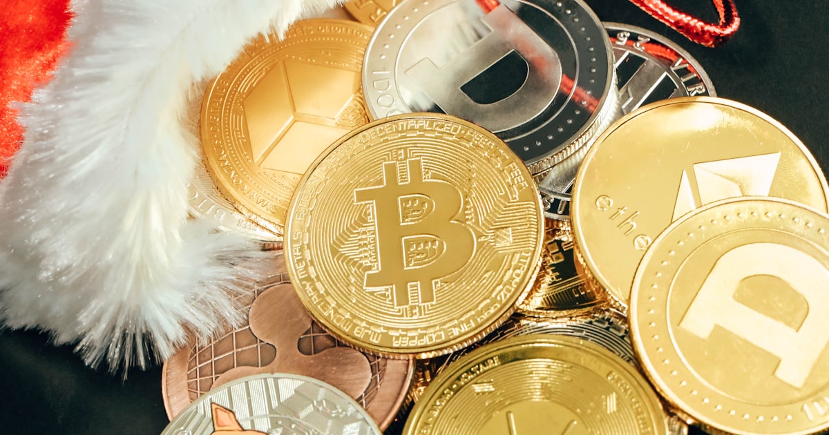 a pile of bitcoins sitting next to a santa hat