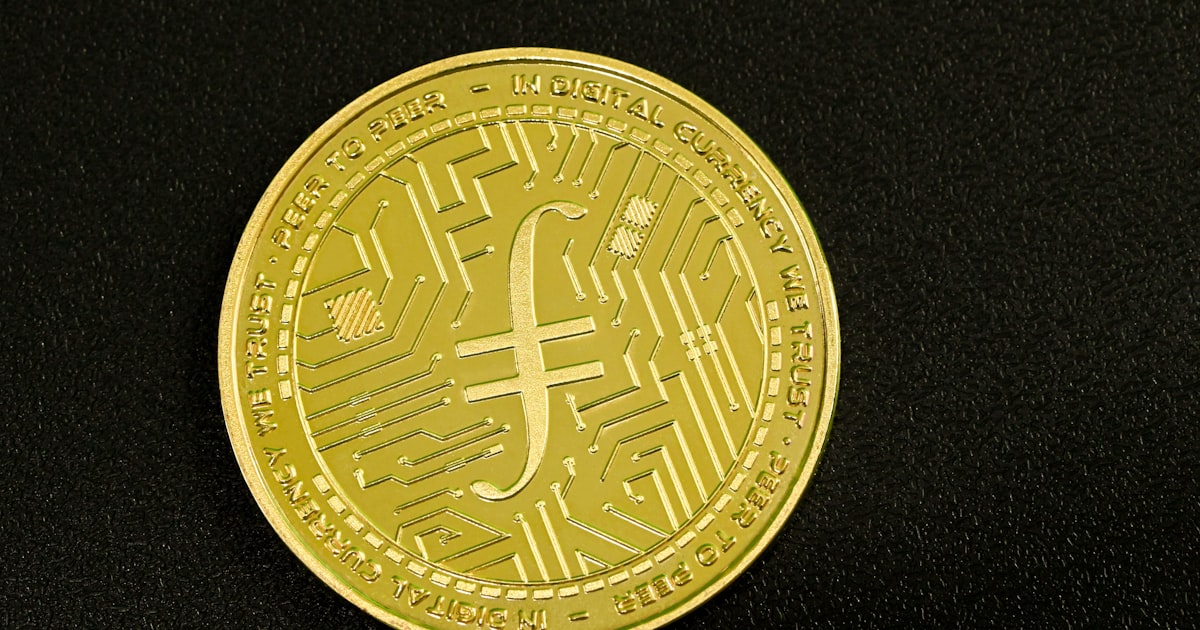 a close up of a gold coin on a black surface