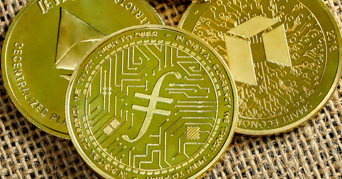 a pile of gold bitcoins sitting on top of a sack of burl