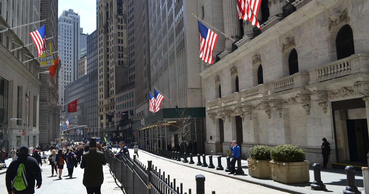 people walking on a street with flags