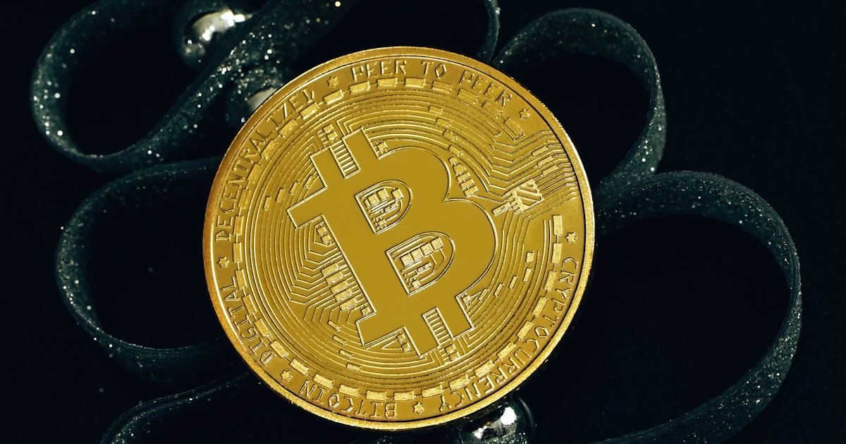 a bit coin sitting on top of a black cloth