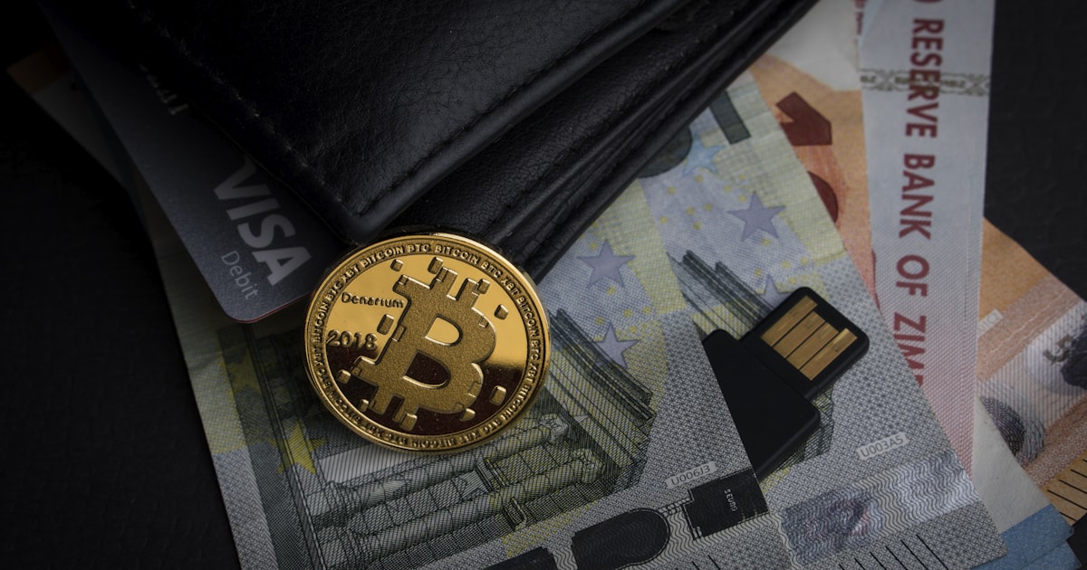 a bitcoin sitting on top of a pile of money