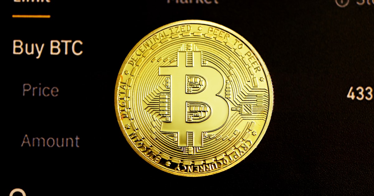 gold round coin on black surface