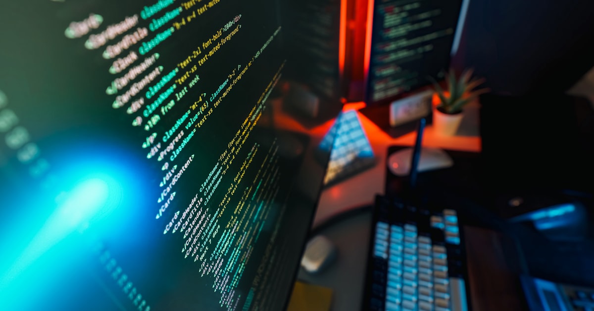 Code displayed on computer screens.