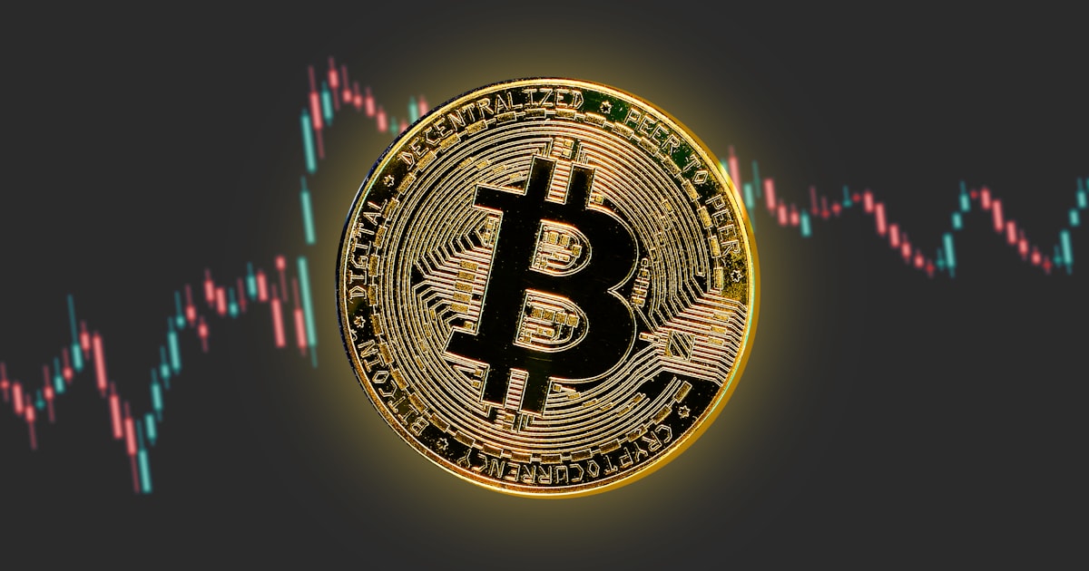 a bitcoin is shown in front of a stock chart