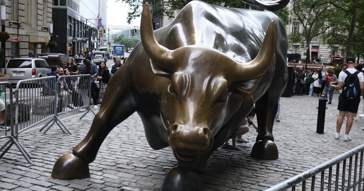 a statue of a bull on a brick street