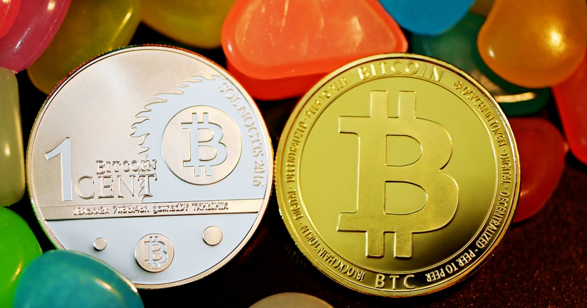 a bit coin sitting next to jelly beans