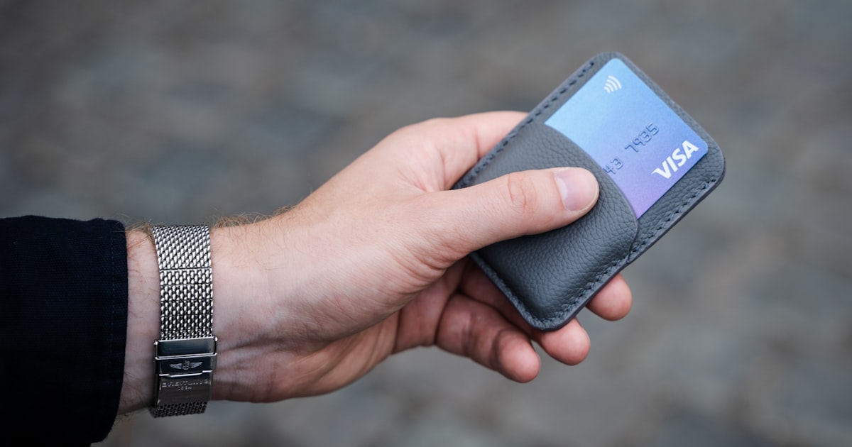 a person holding a credit card in their hand