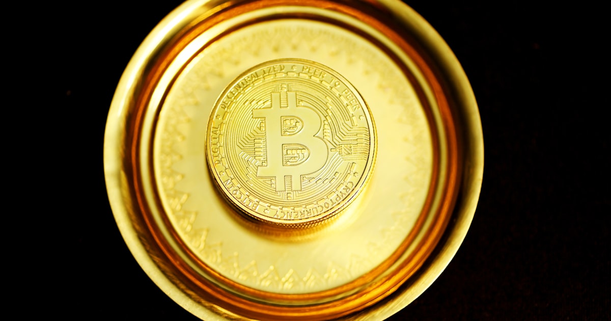 a gold plate with a bit coin on it