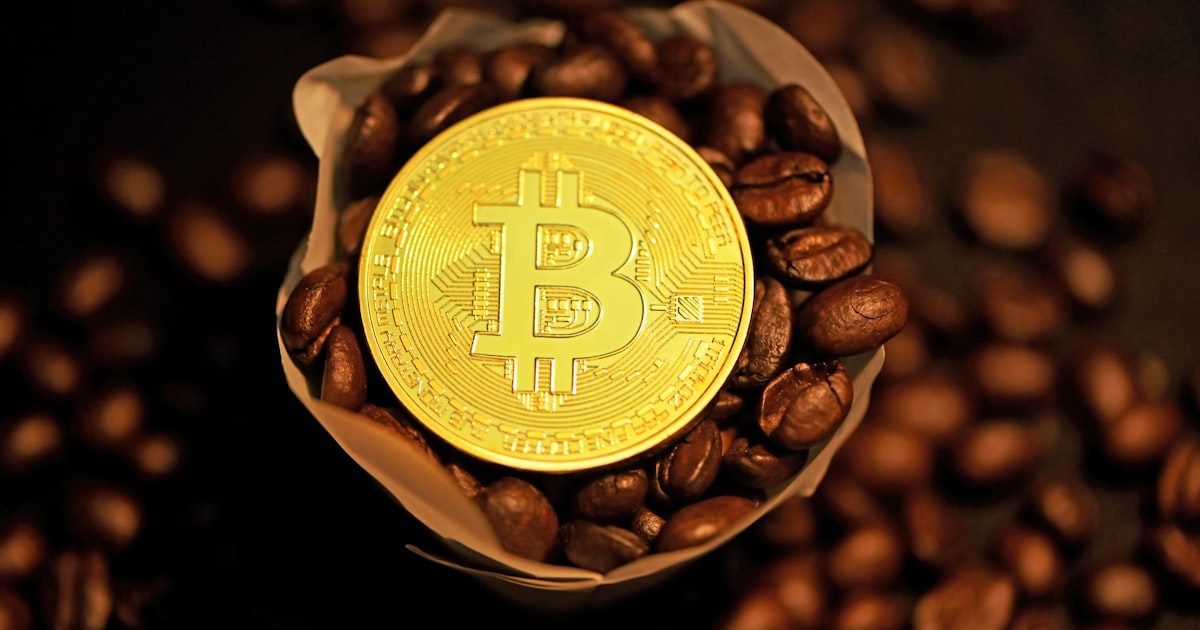 gold round coin on coffee beans
