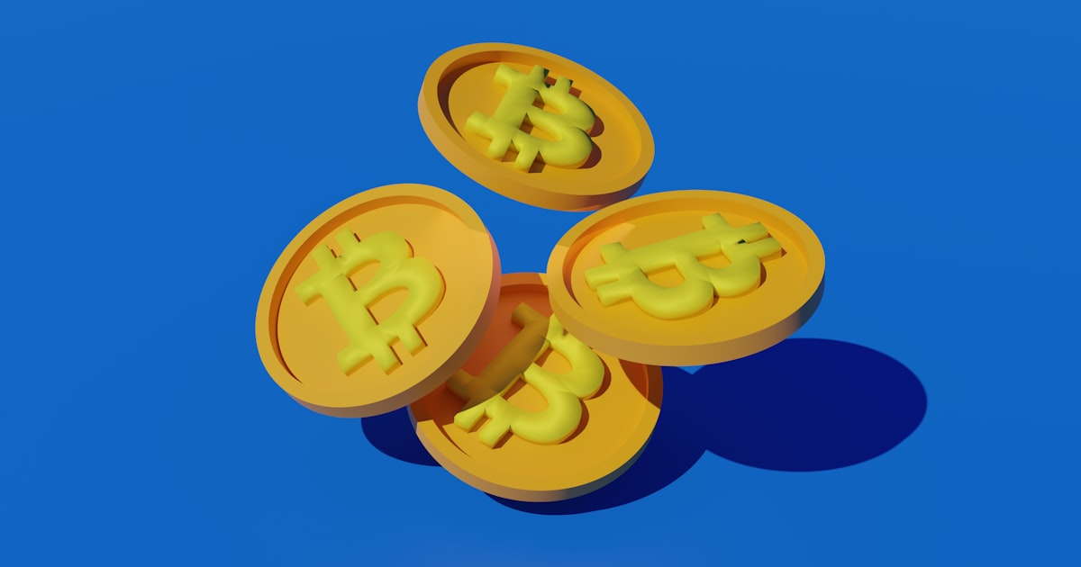 three gold bitcoins sitting on top of each other