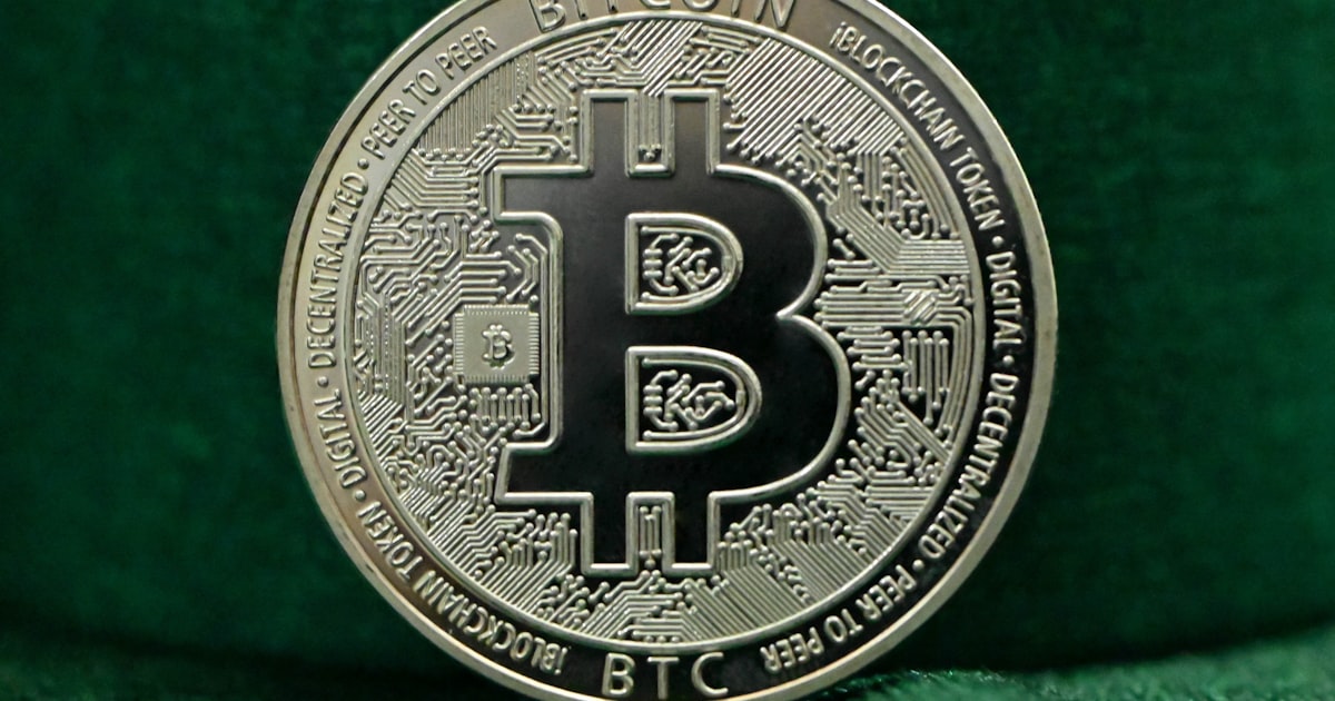 a bit coin sitting on top of a green cloth