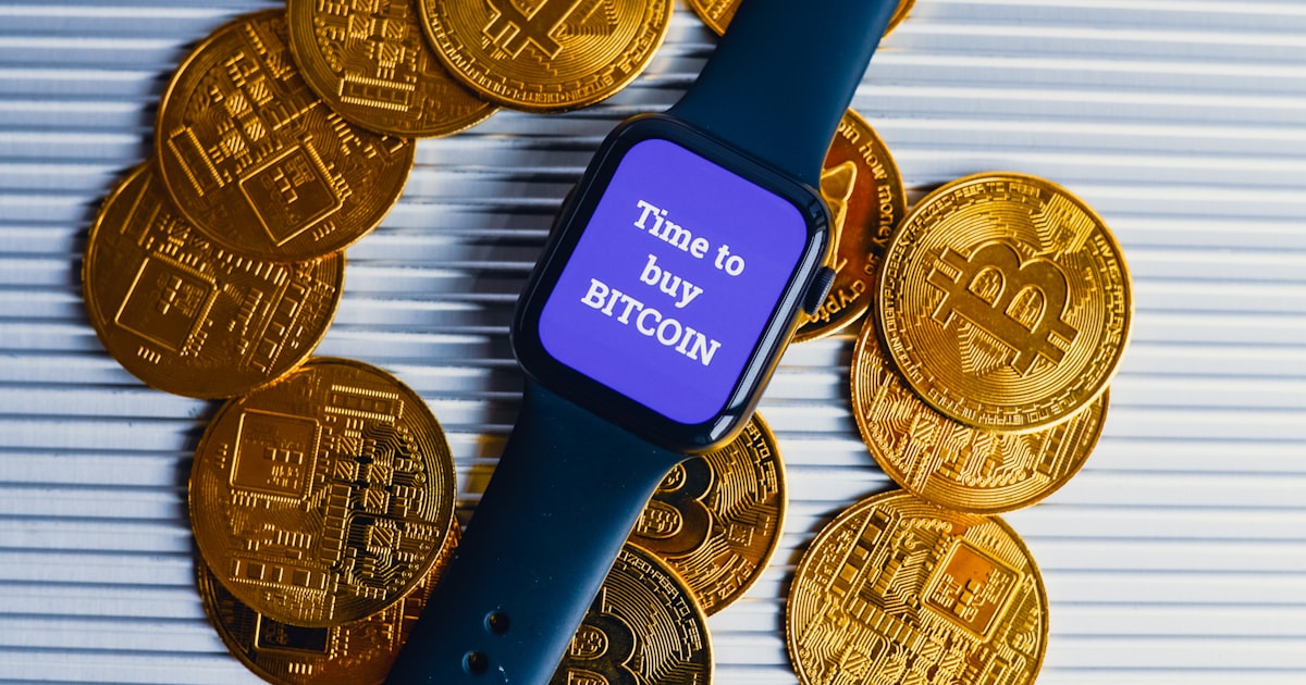 a smart watch sitting on top of a pile of gold coins