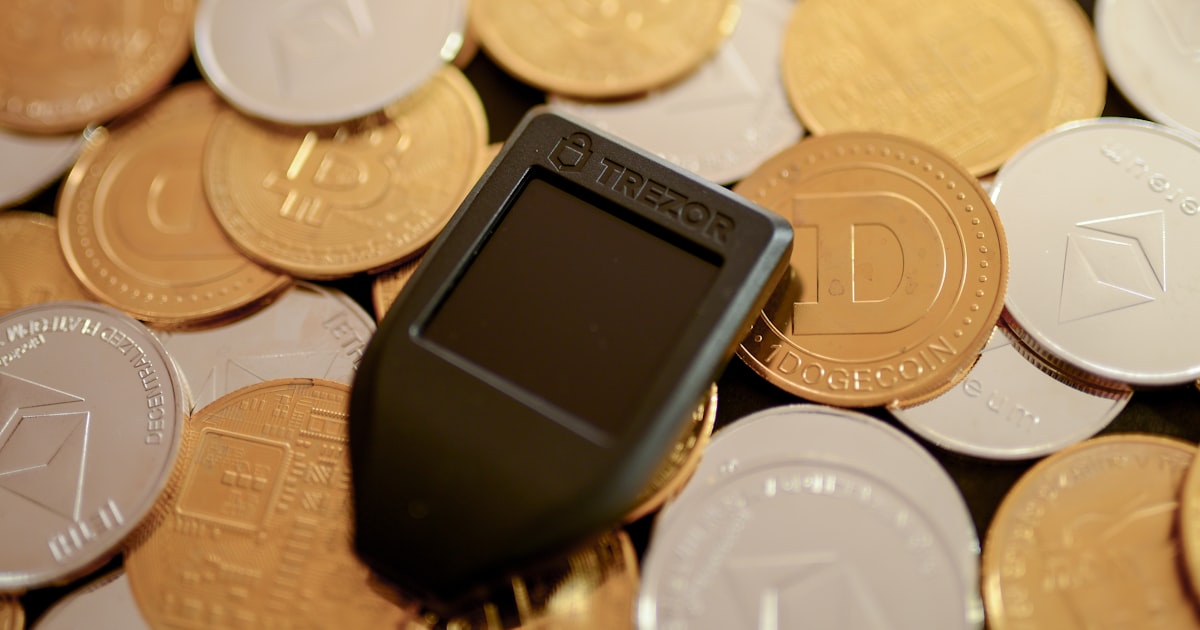 a cell phone sitting on top of a pile of coins