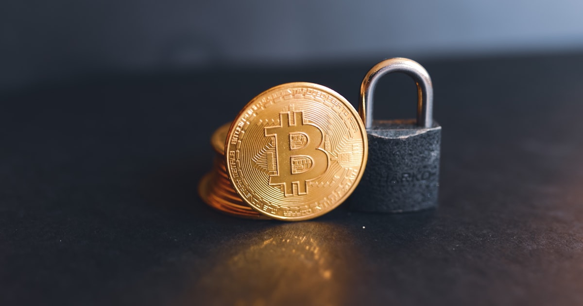 a bit coin sitting on top of a padlock