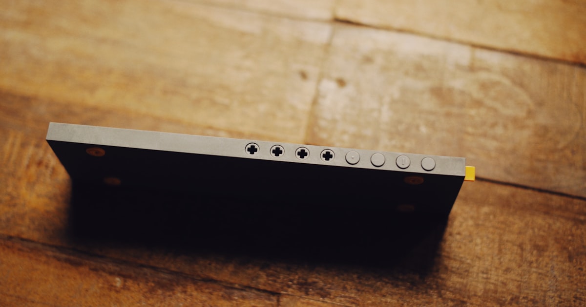 a piece of metal sitting on top of a wooden table